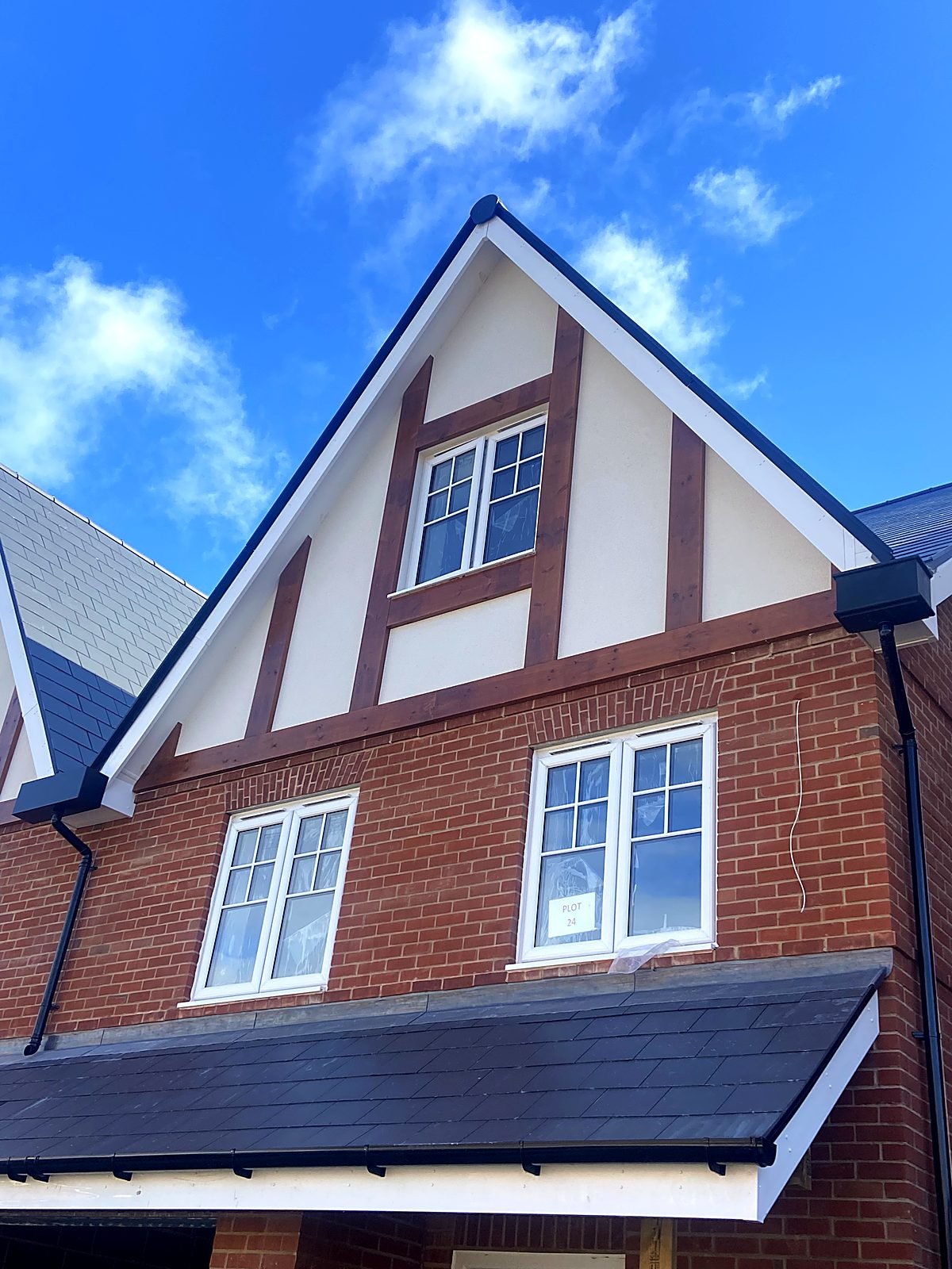 Mock-Tudor gable with dark external timber detailing on a new build home